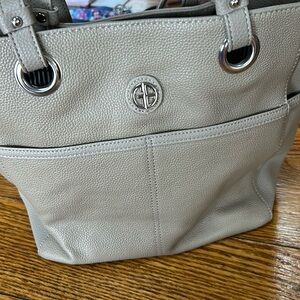 Taupe color leather tote.  Lots of pockets inside and out.